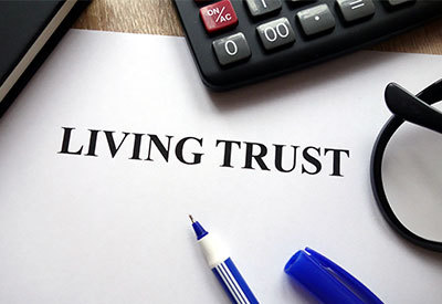living trust document with calculator and pen