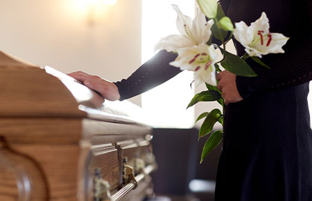 someone holding flowers at a funeral