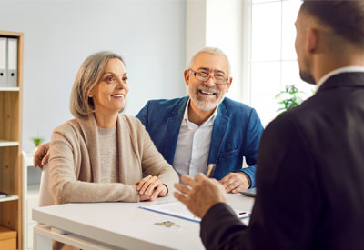 A financial advisor discussing estate planning documents, including a last will and testament, revocable living trust, beneficiary designations, and transfer-on-death accounts