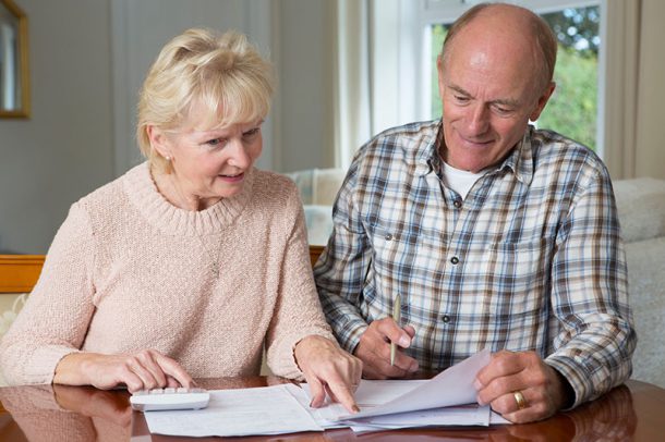 an older couple reviewing their estate plan and beneficiaries