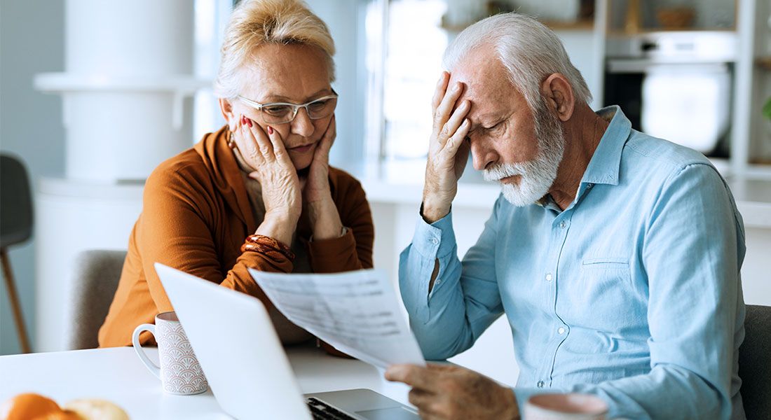 Worried older couple reviewing documents