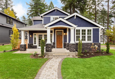 Charming blue home symbolizing multi-state property considerations in estate planning