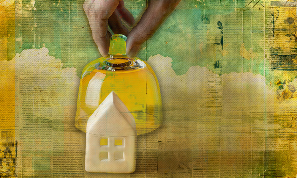 A hand placing a glass cover over a house, symbolizing the importance of safeguarding your home and legacy through careful deed transfer to prevent elder financial abuse.