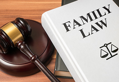 A family law book and gavel on a desk, representing legal complexities in estate planning and intestacy laws.