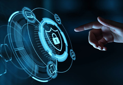 A hand pointing at a digital interface with a glowing blue lock and shield icon, symbolizing cybersecurity
