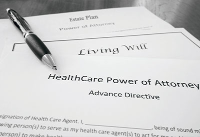 Black and white image showing a fountain pen resting on top of legal documents