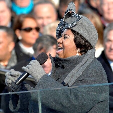 Aretha Franklin singing in front of a crowd