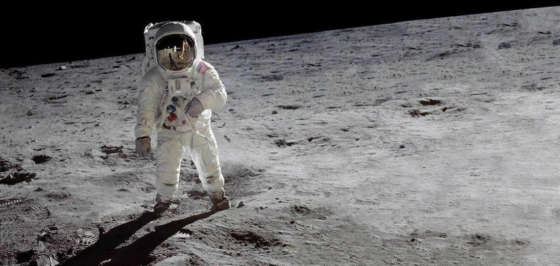 Buzz Aldrin walking on the moon in space suit