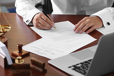 an attorney signing estate planning documents