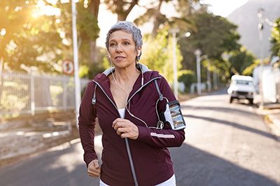 Age perception - Senior woman getting exercise by jogging