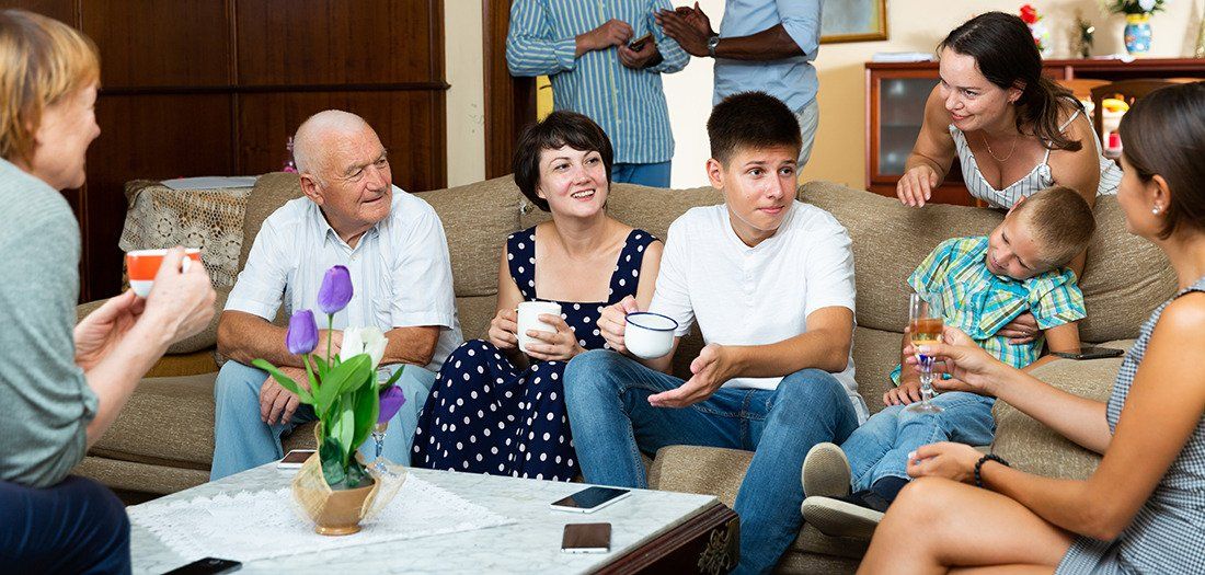 Estate Plan - Blended family sitting on couch having a group conversation