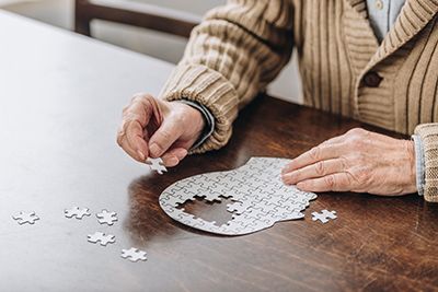 Health - Senior putting together a puzzle