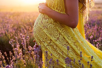 Heath - Pregnant woman walking through a field