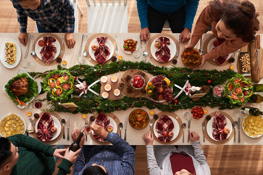 Traditions - Top view of a family sitting down for Christmas dinner