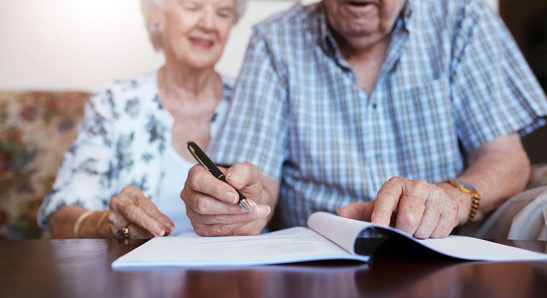 an older couple going through their will to make sure that it is valid