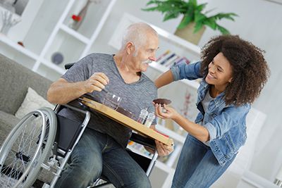 a caregiver taken care of a senior in a wheelchair