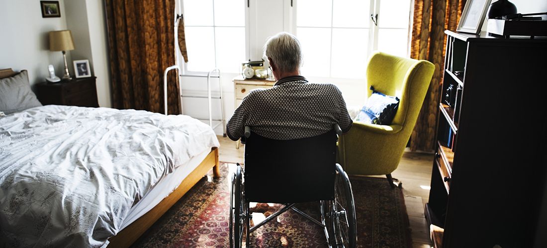 a senior in a wheelchair in a nursing home