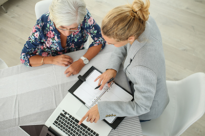 a senior going over her power of attorney with an estate planning attorney
