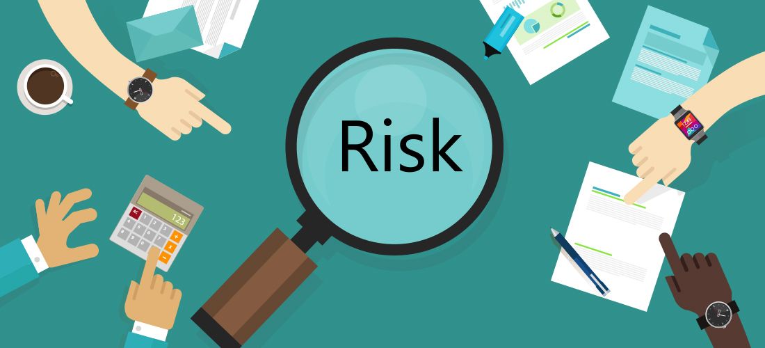 a magnifying glass zooming in on the word RISK
