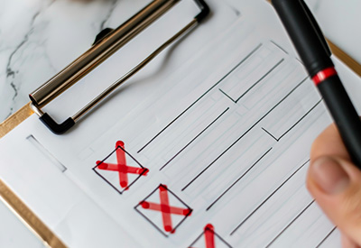 A checklist with red marks highlights potential administrative errors and challenges in managing Miller trusts for Medicaid planning.