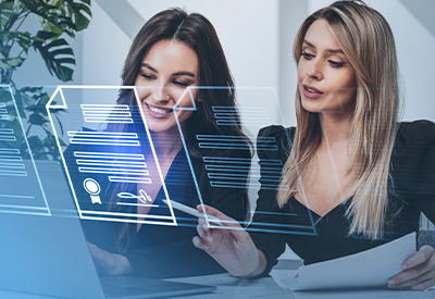 Two women collaborate on estate planning documents, highlighting trust funding and asset transfer for a seamless legacy plan.
