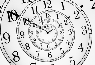 A spiral of clock faces symbolizing the Medicaid look-back period and the importance of timing in estate planning and asset transfer.