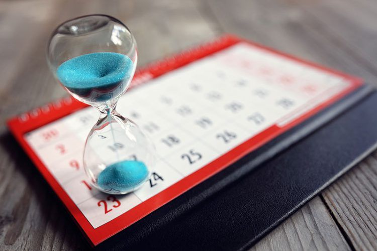an hour glass ontop of a calendar