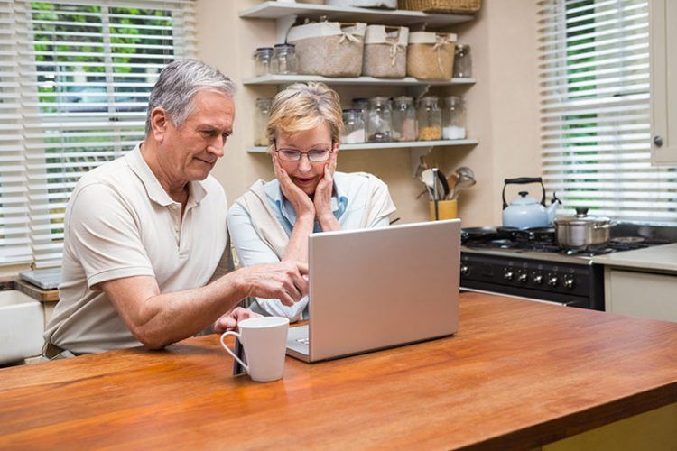 an older couple learning about living trusts on a laptop