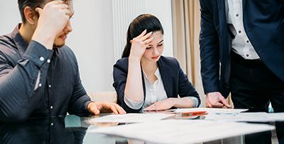 two people stressed out looking at estate planning documents