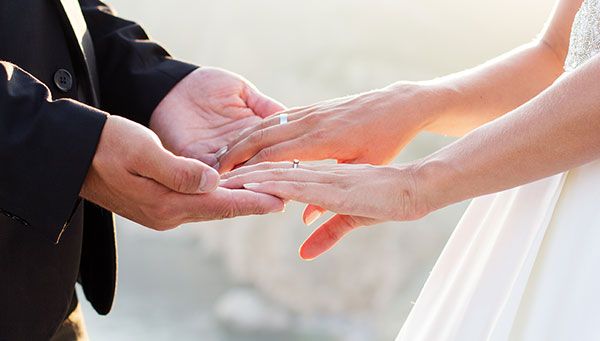a couple holding hands while getting married