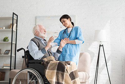 Nurse assisting a senior in a wheelchair