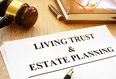 Living trust and estate planning document on desk with a pen and gavel