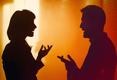  Silhouettes of two people gesturing in conversation against an orange background, suggesting an oral agreement or discussion about promises and inheritance.