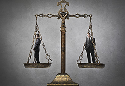 A balanced scale with two individuals, highlighting the importance of fairness and equal distribution in estate planning strategies.