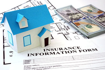 LLC - Paper model of a house, cash, and an insurance form