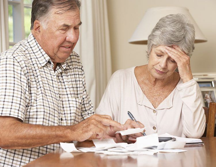Estate Plan - Senior couple worried while reviewing their finances