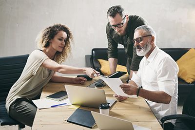 Adult children working with their father on an estate plan