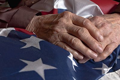 Deceased veteran cluting the U.S. flag
