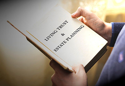 A person holds a book titled 'Living Trust & Estate Planning,' symbolizing the importance of using living trusts to avoid probate and plan effectively.