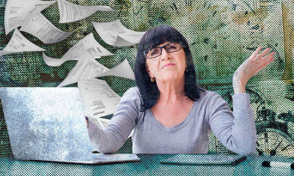 A frustrated senior woman shrugs at her laptop as papers fly around her, symbolizing the hidden risks of DIY wills and the potential for costly estate planning failures.