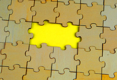 A wooden puzzle with a missing piece over a bright yellow background symbolizes DIY will risks, will validity requirements, and potential estate planning disasters due to missing legal elements.