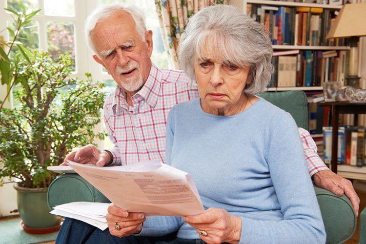 Worried elderly couple