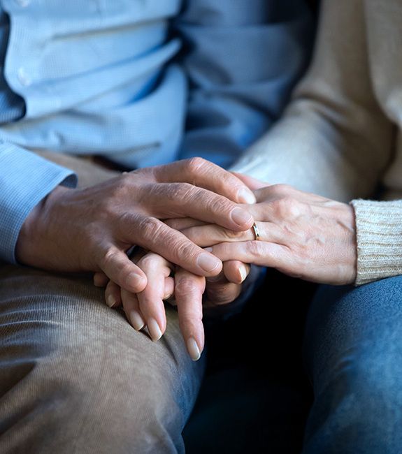 Close up of senior couple holding hands